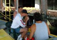 Alex and John diligently watching Dennis performing actual work